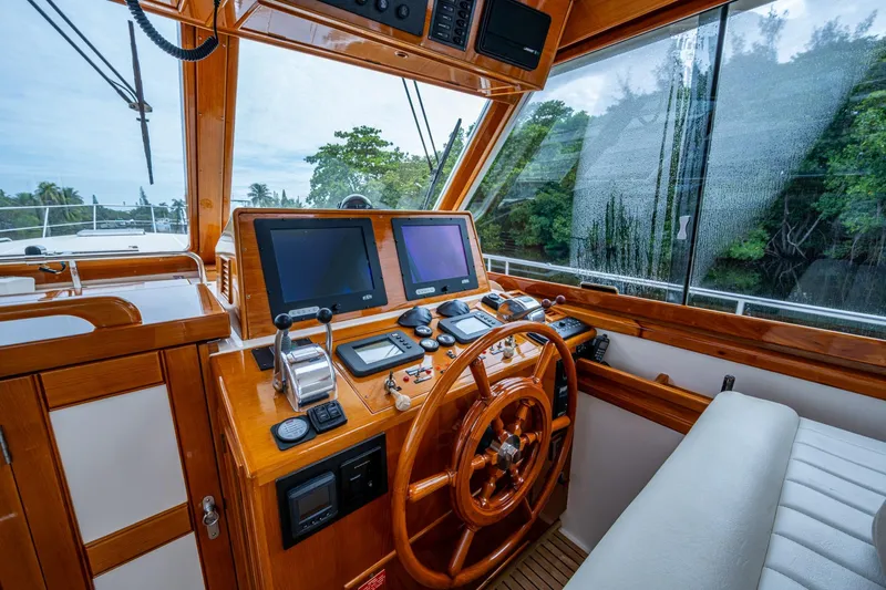 Bright Star Yacht Photos Pics Helm of 2003 Grand Banks 49 Eastbay HX with wooden steering wheel and navigation screens.