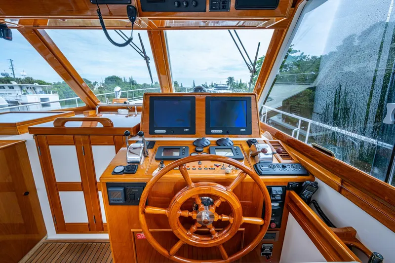 Bright Star Yacht Photos Pics Helm of 2003 Grand Banks 49 Eastbay HX with wooden steering wheel and navigation screens.