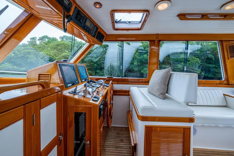 Bright Star Yacht Photos Pics Luxurious 2003 Grand Banks 49 Eastbay HX yacht interior with polished wood and navigation equipment.