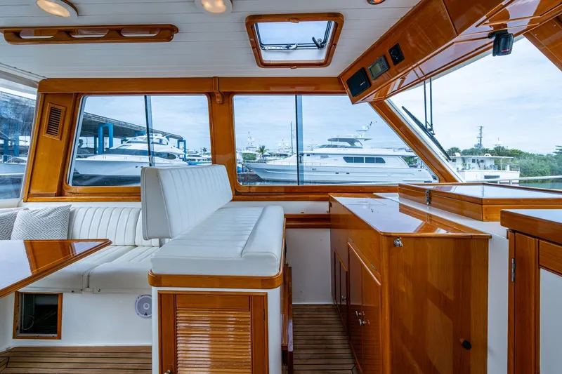 Bright Star Yacht Photos Pics Interior of 2003 Grand Banks 49 Eastbay HX yacht with polished wood and white seating.
