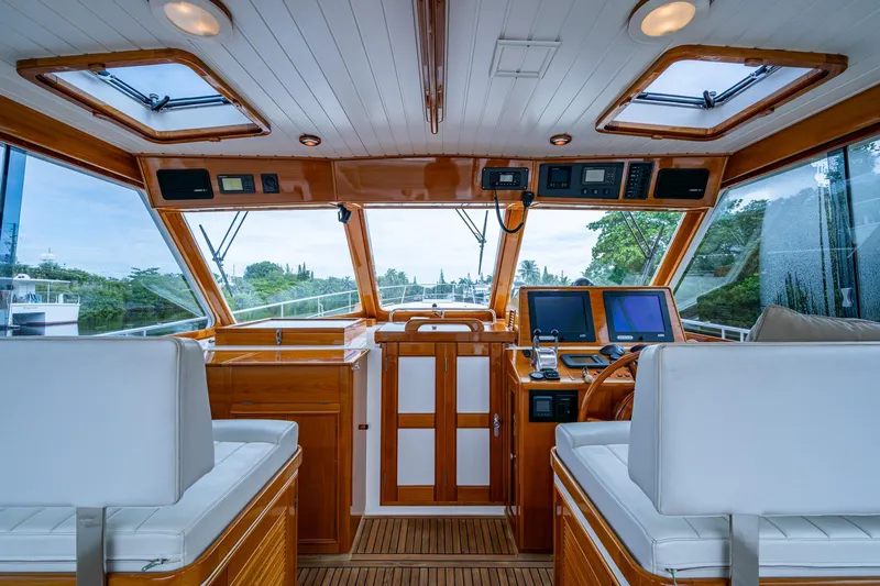 Bright Star Yacht Photos Pics Interior of 2003 Grand Banks 49 Eastbay HX yacht with wooden finish and navigation equipment.