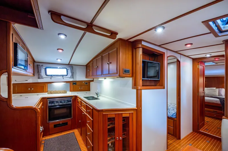 Bright Star Yacht Photos Pics Luxurious 2003 Grand Banks 49 Eastbay HX yacht interior with modern kitchen and cozy cabin.