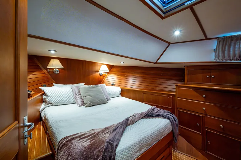 Bright Star Yacht Photos Pics Luxurious cabin interior of 2003 Grand Banks 49 Eastbay HX yacht, featuring elegant wood finishes.