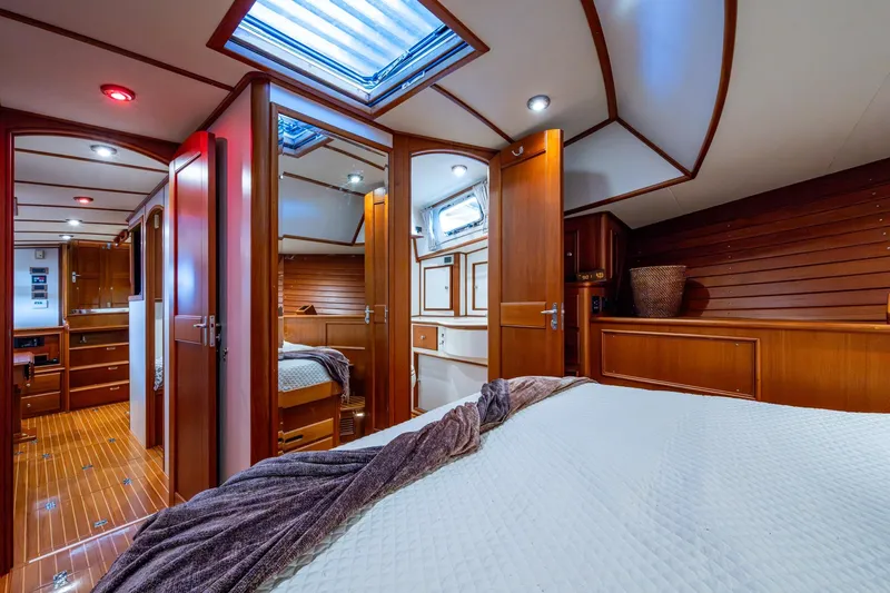 Bright Star Yacht Photos Pics Luxurious 2003 Grand Banks 49 Eastbay HX yacht interior with elegant wood finish and cozy bedroom.