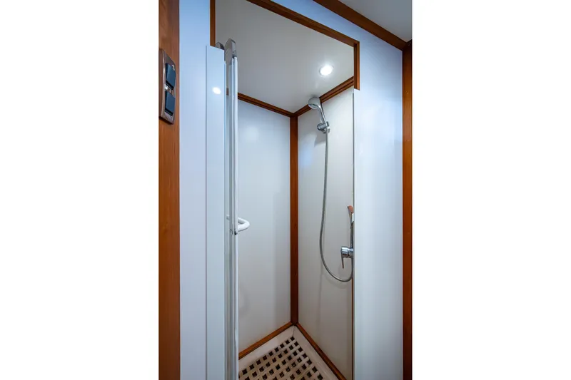 Bright Star Yacht Photos Pics Shower area in 2003 Grand Banks 49 Eastbay HX yacht with wooden accents.