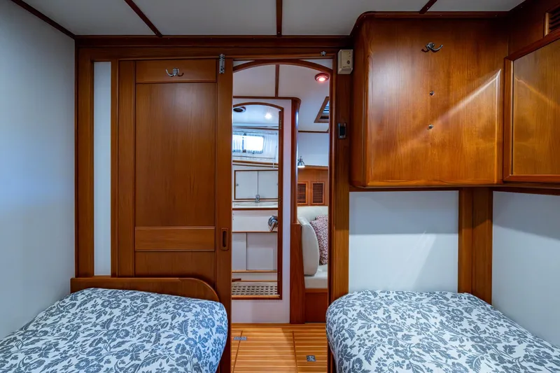 Bright Star Yacht Photos Pics Luxurious 2003 Grand Banks 49 Eastbay HX cabin with twin beds and elegant wood finish.