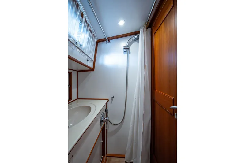 Bright Star Yacht Photos Pics 2003 Grand Banks 49 Eastbay HX yacht bathroom with shower and wooden accents.