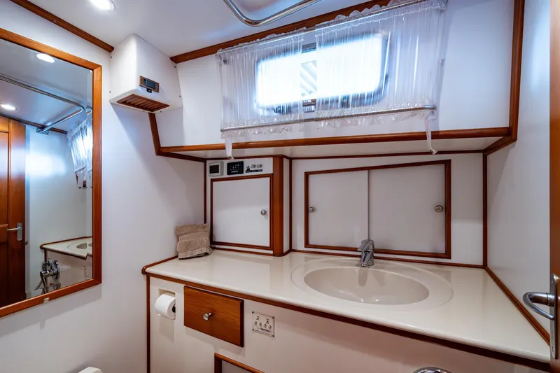 Bright Star Yacht Photos Pics Luxurious bathroom interior of 2003 Grand Banks 49 Eastbay HX yacht, featuring elegant wood accents.