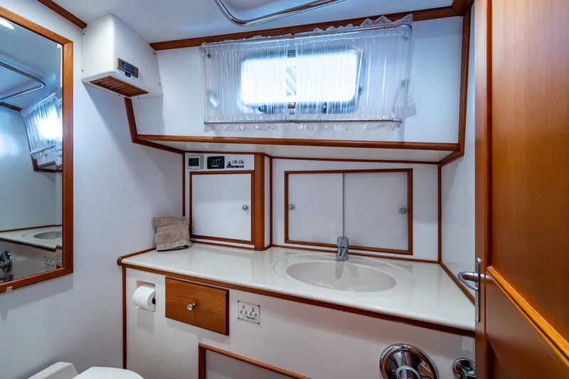Bright Star Yacht Photos Pics Luxurious bathroom interior of 2003 Grand Banks 49 Eastbay HX yacht, featuring wood accents.