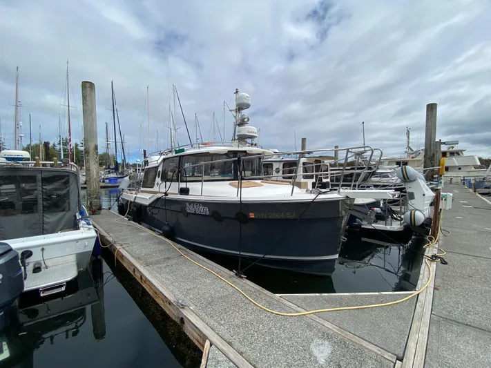 Sal-taire Yacht Photos Pics 2016 Ranger Tugs R-29S docked at a marina, surrounded by other boats.