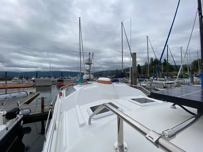 Sal-taire Yacht Photos Pics 2016 Ranger Tugs R-29S docked at a marina with sailboats and cloudy sky.