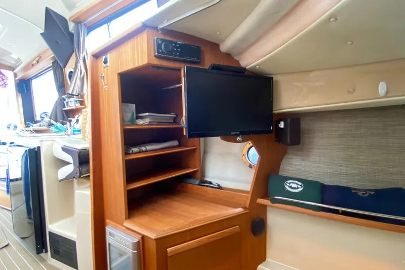 Sal-taire Yacht Photos Pics Interior of 2016 Ranger Tugs R-29S with TV, shelves, and porthole.