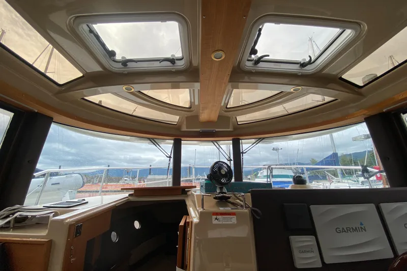Sal-taire Yacht Photos Pics Interior view of 2016 Ranger Tugs R-29S boat with panoramic windows and Garmin equipment.