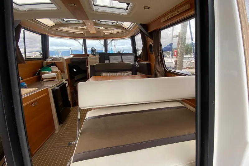 Sal-taire Yacht Photos Pics Interior of 2016 Ranger Tugs R-29S boat, featuring seating and navigation area.