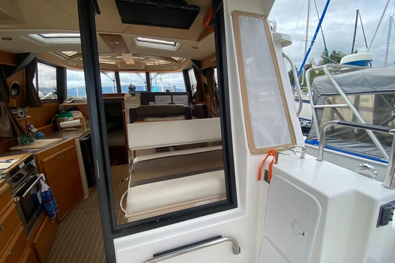 Sal-taire Yacht Photos Pics Interior view of 2016 Ranger Tugs R-29S boat, featuring kitchen and seating area.