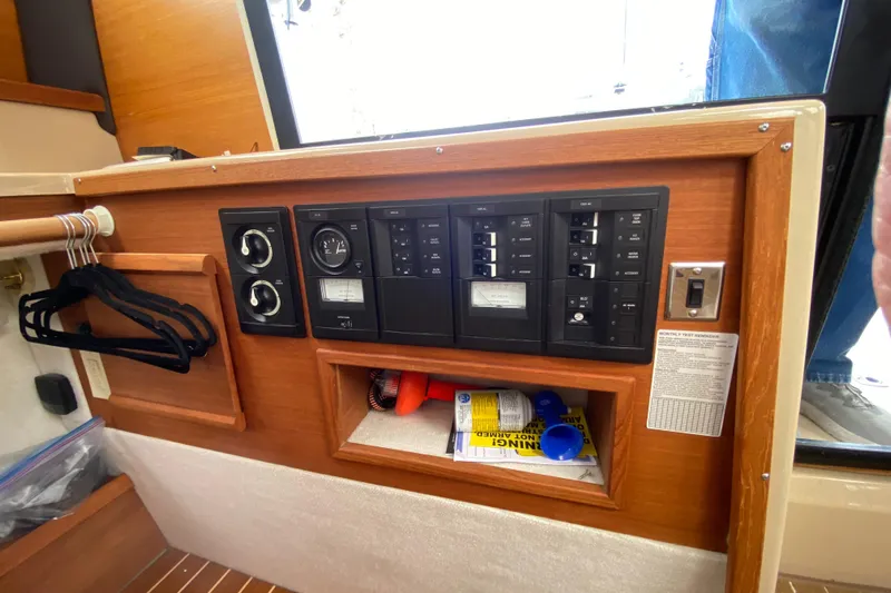 Sal-taire Yacht Photos Pics 2016 Ranger Tugs R-29S interior control panel with switches and storage compartment.