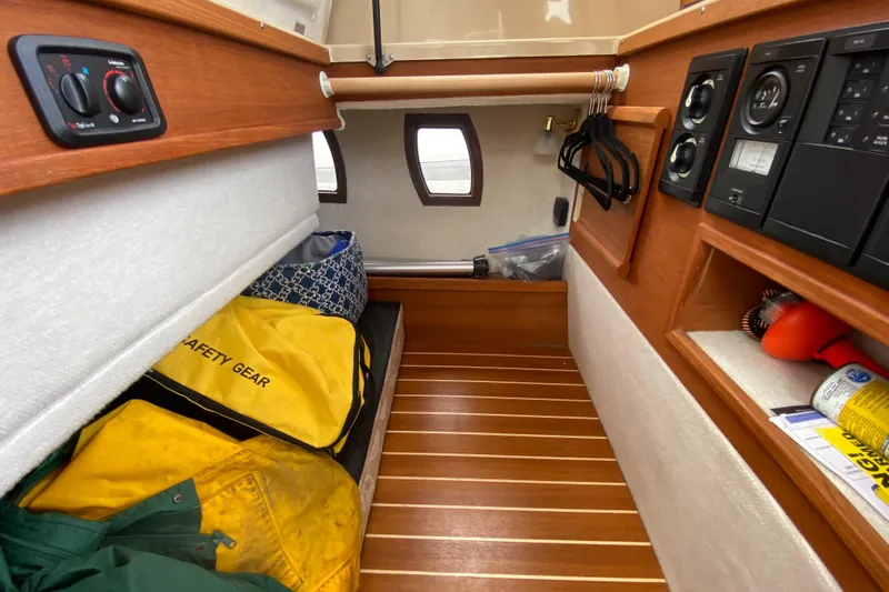 Sal-taire Yacht Photos Pics 2016 Ranger Tugs R-29S cabin interior with safety gear and wooden flooring.