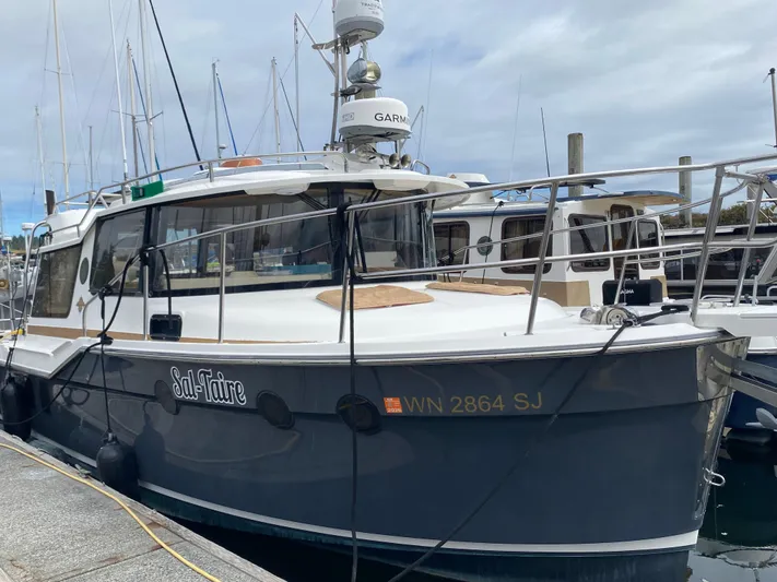 Sal-taire Yacht Photos Pics 2016 Ranger Tugs R-29S boat docked at marina, overcast sky.
