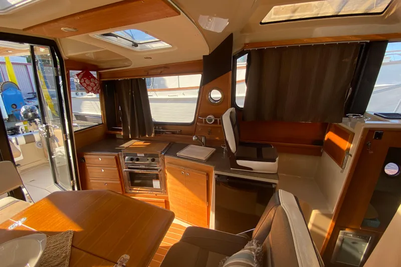 Sal-taire Yacht Photos Pics Interior of 2016 Ranger Tugs R-29S boat with kitchen and seating area.