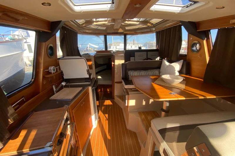 Sal-taire Yacht Photos Pics 2016 Ranger Tugs R-29S interior with wood finishes, dining area, and natural light.