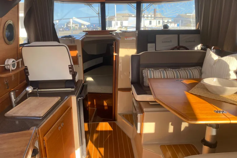 Sal-taire Yacht Photos Pics Interior of 2016 Ranger Tugs R-29S with cozy seating and wooden finishes.