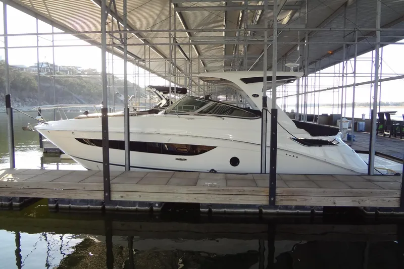 Rancho Del Lago Yacht Photos Pics 2017 Sea Ray Sundancer 350 yacht docked in a marina under a covered structure.
