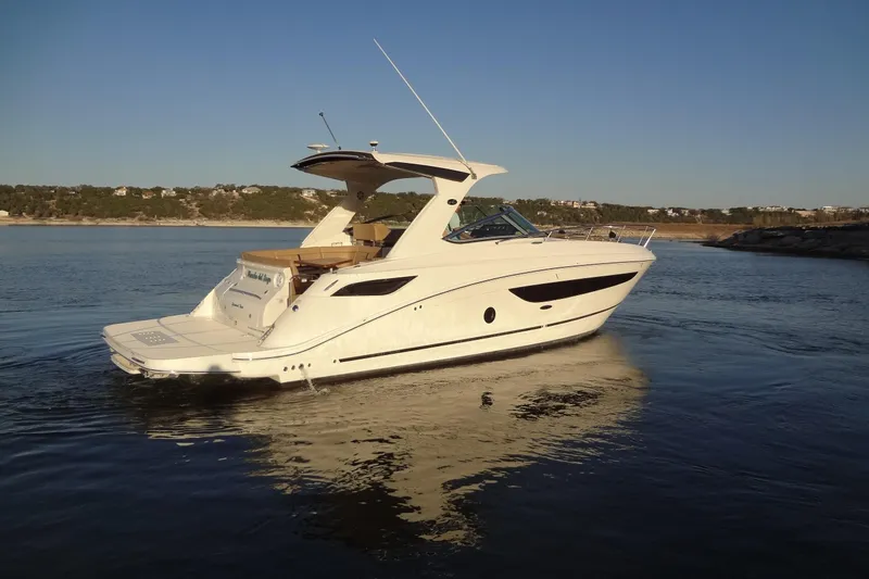 Rancho Del Lago Yacht Photos Pics 2017 Sea Ray Sundancer 350 yacht cruising on a serene lake at sunset.