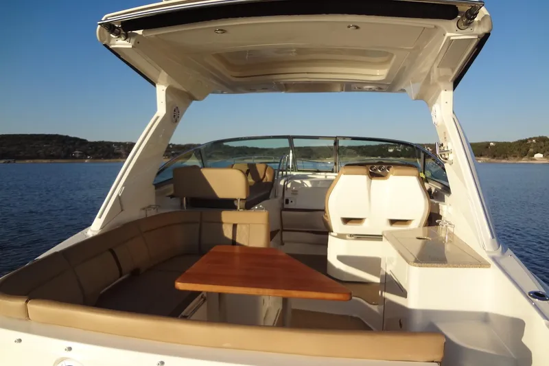 Rancho Del Lago Yacht Photos Pics 2017 Sea Ray Sundancer 350 interior with seating and table on calm water.