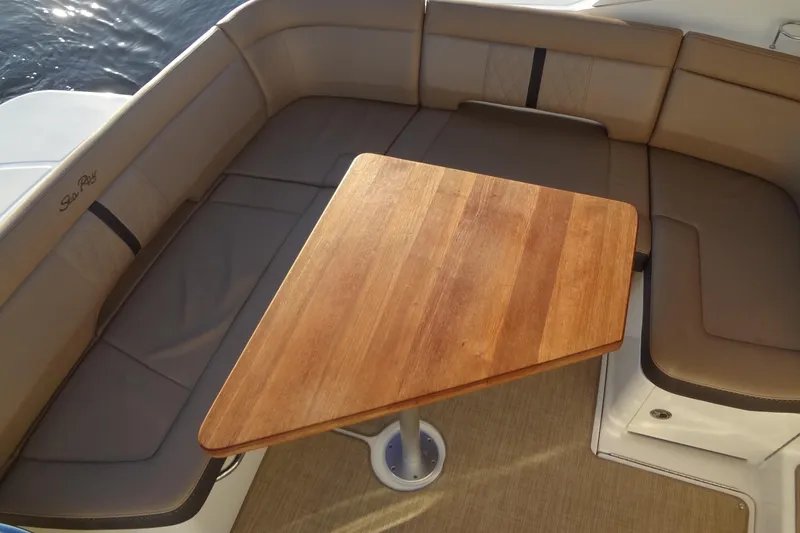 Rancho Del Lago Yacht Photos Pics 2017 Sea Ray Sundancer 350 interior with wooden table and cushioned seating.