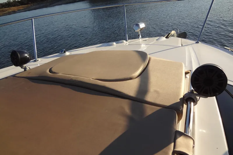Rancho Del Lago Yacht Photos Pics 2017 Sea Ray Sundancer 350 boat deck with sun pad, speakers, and water view.