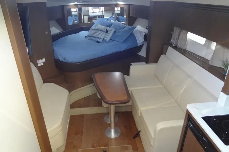 Rancho Del Lago Yacht Photos Pics 2017 Sea Ray Sundancer 350 interior with cozy seating, table, and bed.
