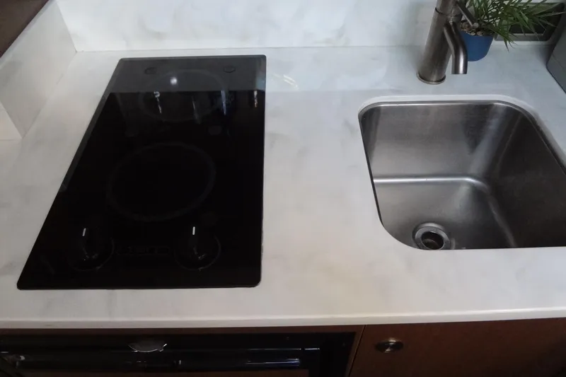 Rancho Del Lago Yacht Photos Pics Modern kitchen area in 2017 Sea Ray Sundancer 350 yacht with stove and sink.