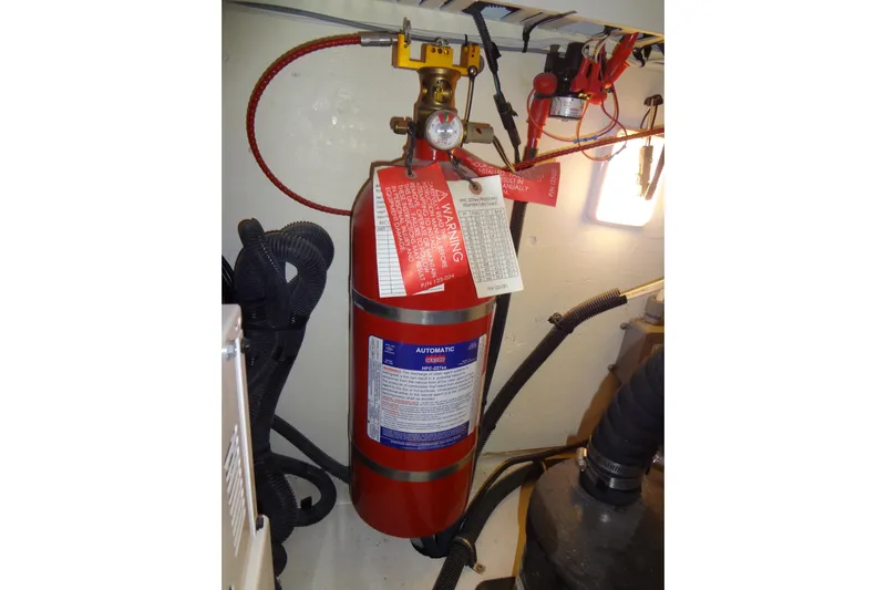 Rancho Del Lago Yacht Photos Pics Fire extinguisher in 2017 Sea Ray Sundancer 350 engine room, with safety tags and wiring.