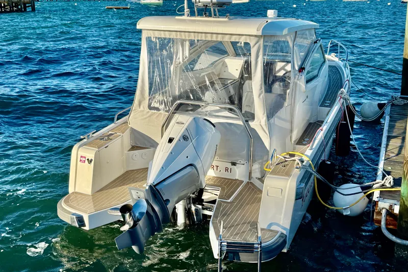Yucca Flats Yacht Photos Pics 2023 Nimbus Weekender 9 boat docked, featuring a powerful outboard motor and sleek design.