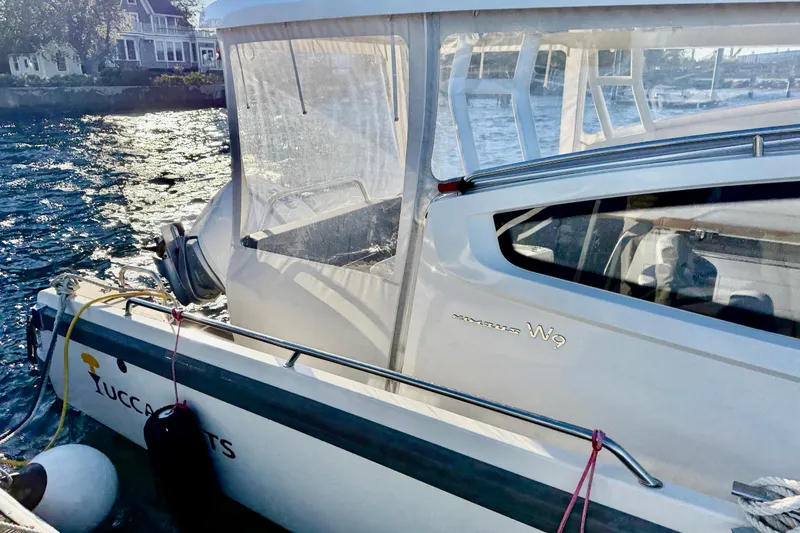 Yucca Flats Yacht Photos Pics 2023 Nimbus Weekender 9 boat docked by waterfront homes.