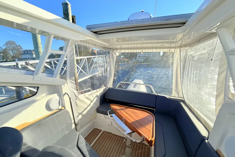 Yucca Flats Yacht Photos Pics Interior of 2023 Nimbus Weekender 9 boat with seating and wooden table.