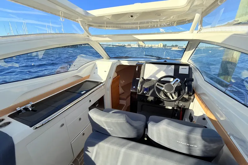 Yucca Flats Yacht Photos Pics 2023 Nimbus Weekender 9 boat interior with steering wheel, dashboard, and seating.
