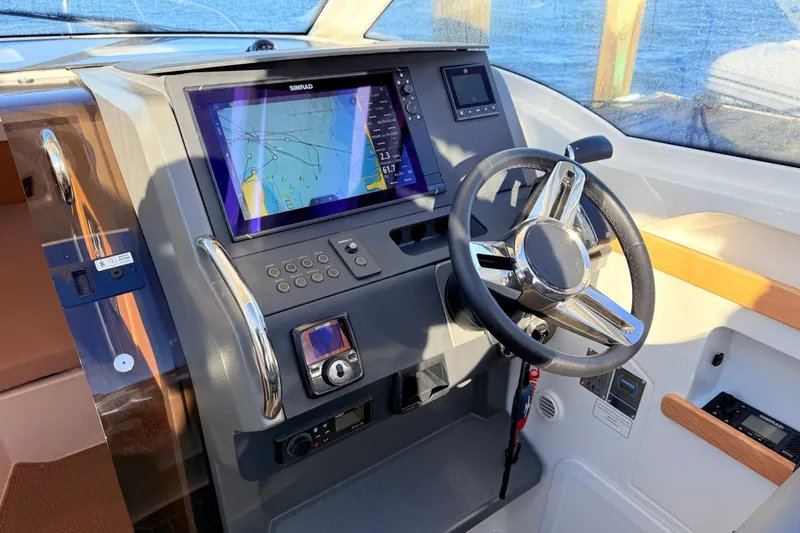 Yucca Flats Yacht Photos Pics 2023 Nimbus Weekender 9 dashboard with steering wheel and navigation display.