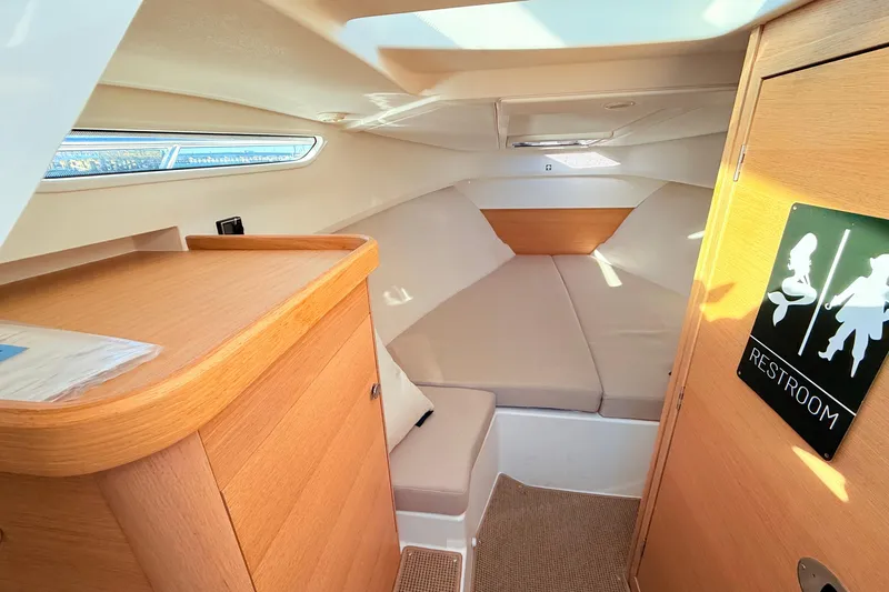 Yucca Flats Yacht Photos Pics Cozy interior of 2023 Nimbus Weekender 9 boat with restroom sign and comfortable seating.