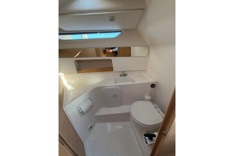 Yucca Flats Yacht Photos Pics 2023 Nimbus Weekender 9 boat bathroom with modern fixtures and compact design.
