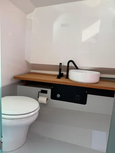  Yacht Photos Pics Modern bathroom in 2024 Goldfish 46 Open boat with sleek fixtures and wooden countertop.