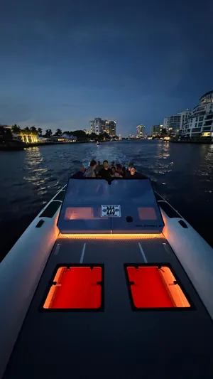 Yacht Photos Pics 2024 Goldfish 46 Open boat cruising at night on a city river.