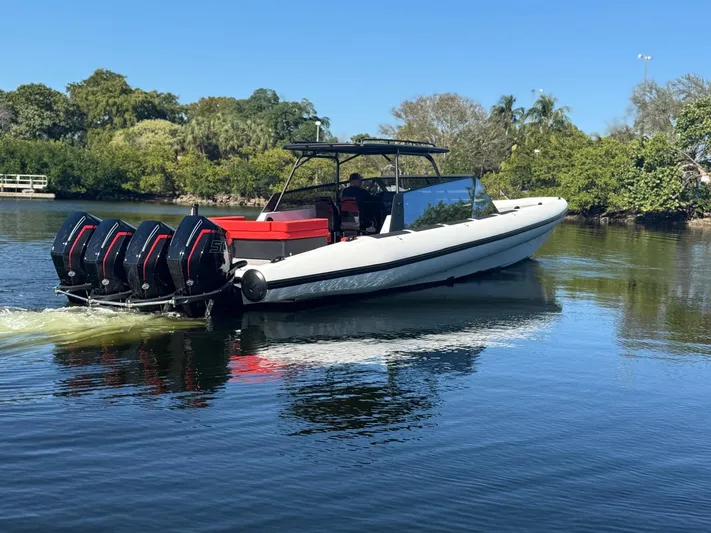  Yacht Photos Pics 2024 Goldfish 46 Open boat with four engines cruising on a calm lake.