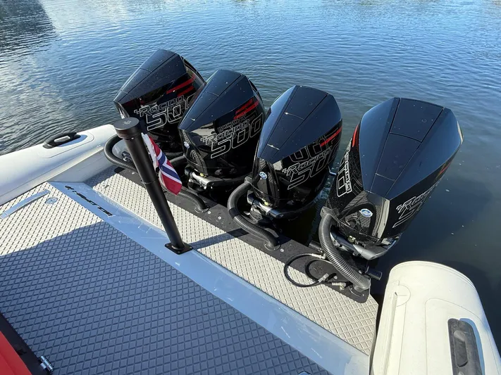  Yacht Photos Pics Four powerful outboard motors on a 2024 Goldfish 46 Open boat, docked on calm water.