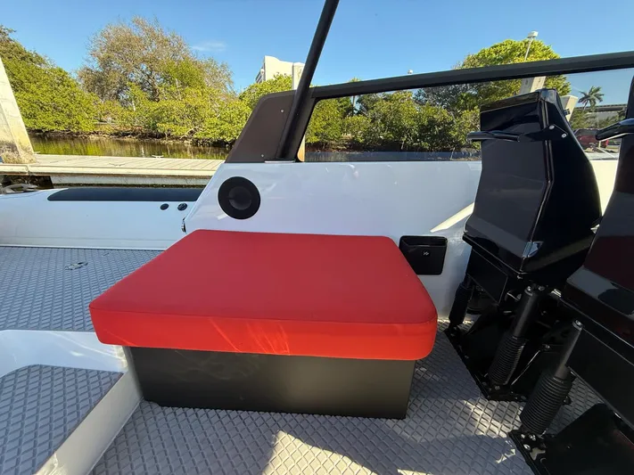  Yacht Photos Pics 2024 Goldfish 46 Open boat with red seat cushion, sleek design, and outdoor setting.