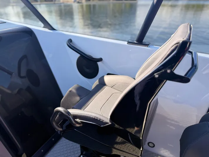  Yacht Photos Pics 2024 Goldfish 46 Open boat seat with sleek design and waterfront view.