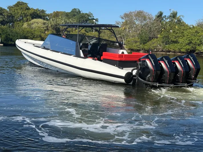  Yacht Photos Pics 2024 Goldfish 46 Open boat with triple engines on a calm waterway.
