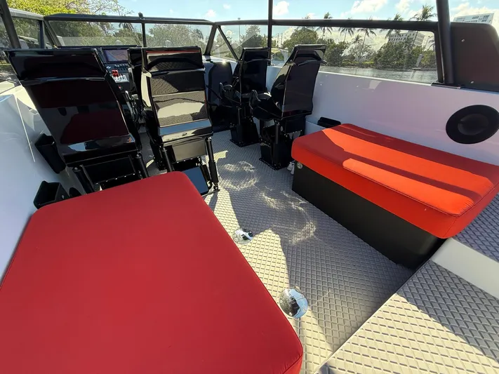  Yacht Photos Pics 2024 Goldfish 46 Open boat interior with red seating and modern design.