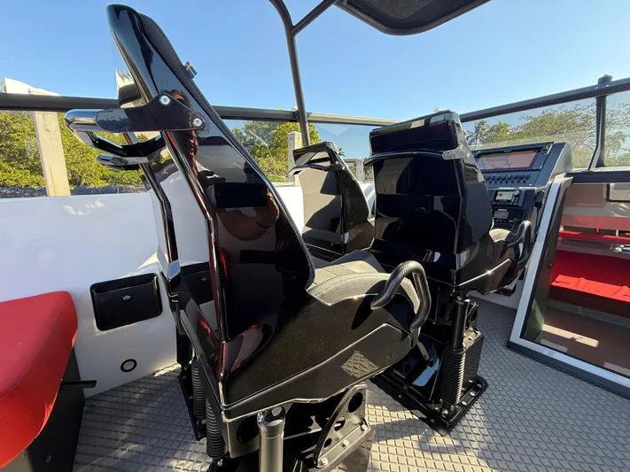  Yacht Photos Pics 2024 Goldfish 46 Open boat interior with sleek black seats and modern dashboard.