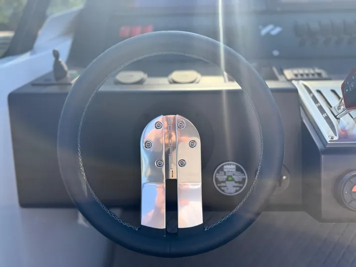  Yacht Photos Pics Steering wheel of 2024 Goldfish 46 Open boat, featuring modern controls and sleek design.